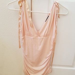 Light pink v-neck top.